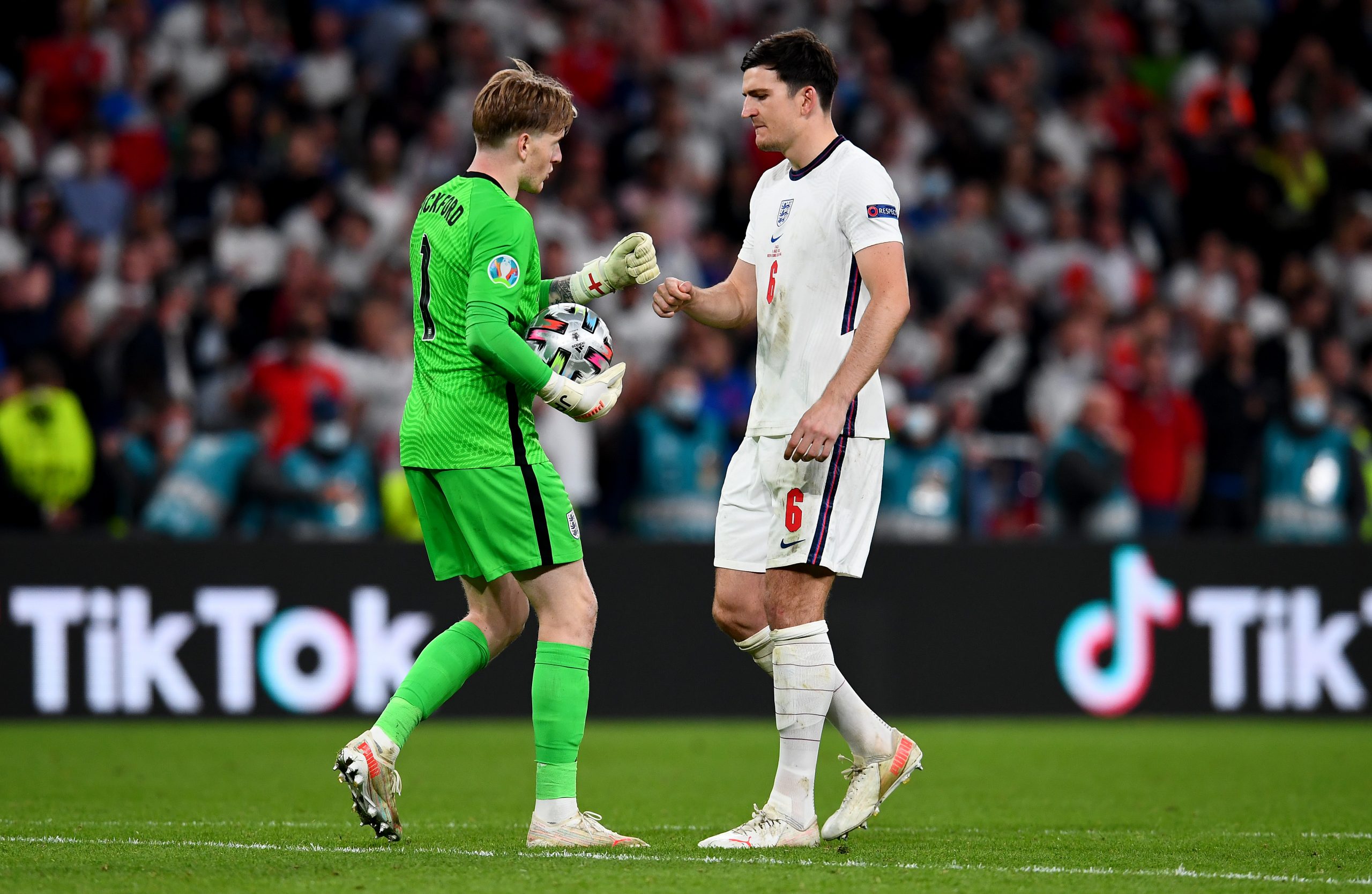 Harry Maguire of England interacts with Jordan Pickford of England during the penalty shoot out during the UEFA Euro 2020 Championship Final between Italy and England at Wembley Stadium on July 11, 2021 in London, England.