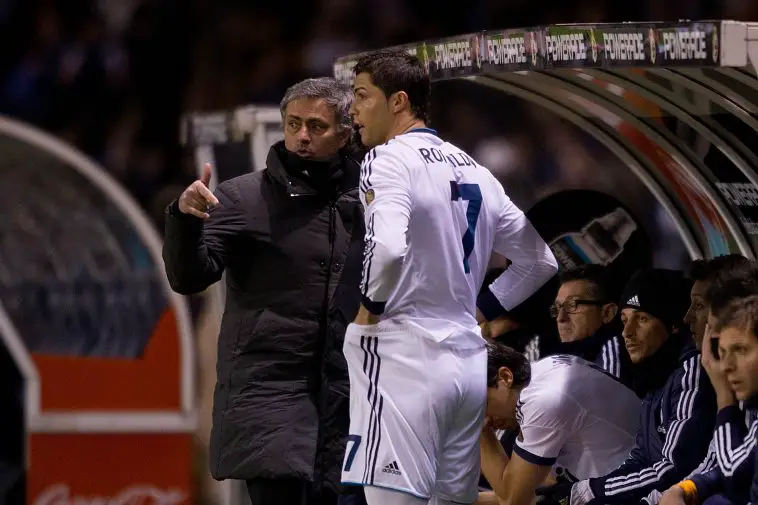 Head coach Jose Mourinho (L) of Real Madrid CF gives instructions to Cristiano Ronaldo (2ndl) on the desk during the La Liga match between RC Deportivo La Coruna and Real Madrid CF at Riazor Stadium on February 23, 2013 in La Coruna, Spain