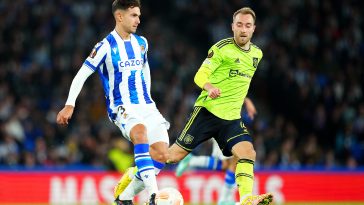 Martin Zubimendi of Real Sociedad is challenged by whilst under pressure from Christian Eriksen of Manchester United during the UEFA Europa League group E match between Real Sociedad and Manchester United at Reale Arena on November 03, 2022 in San Sebastian, Spain