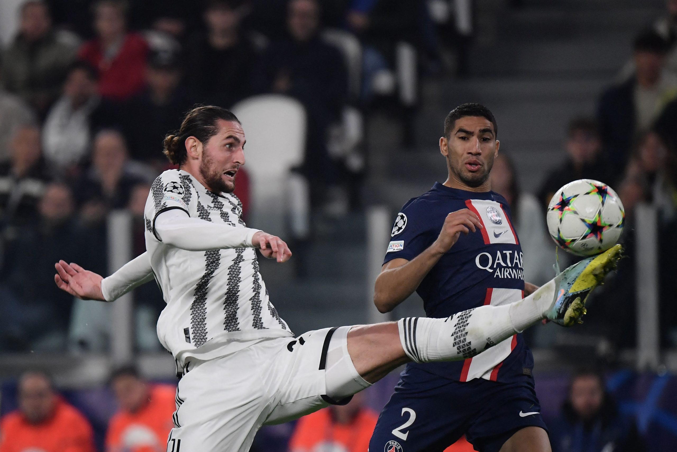 Juventus' French midfielder Adrien Rabiot (L) fights for the ball with Paris Saint-Germain's Moroccan defender Achraf Hakimi during the UEFA Champions League 1st round day 6 group H football match between Juventus Turin and Paris Saint-Germain (PSG) at the Juventus stadium in Turin on November 2, 2022