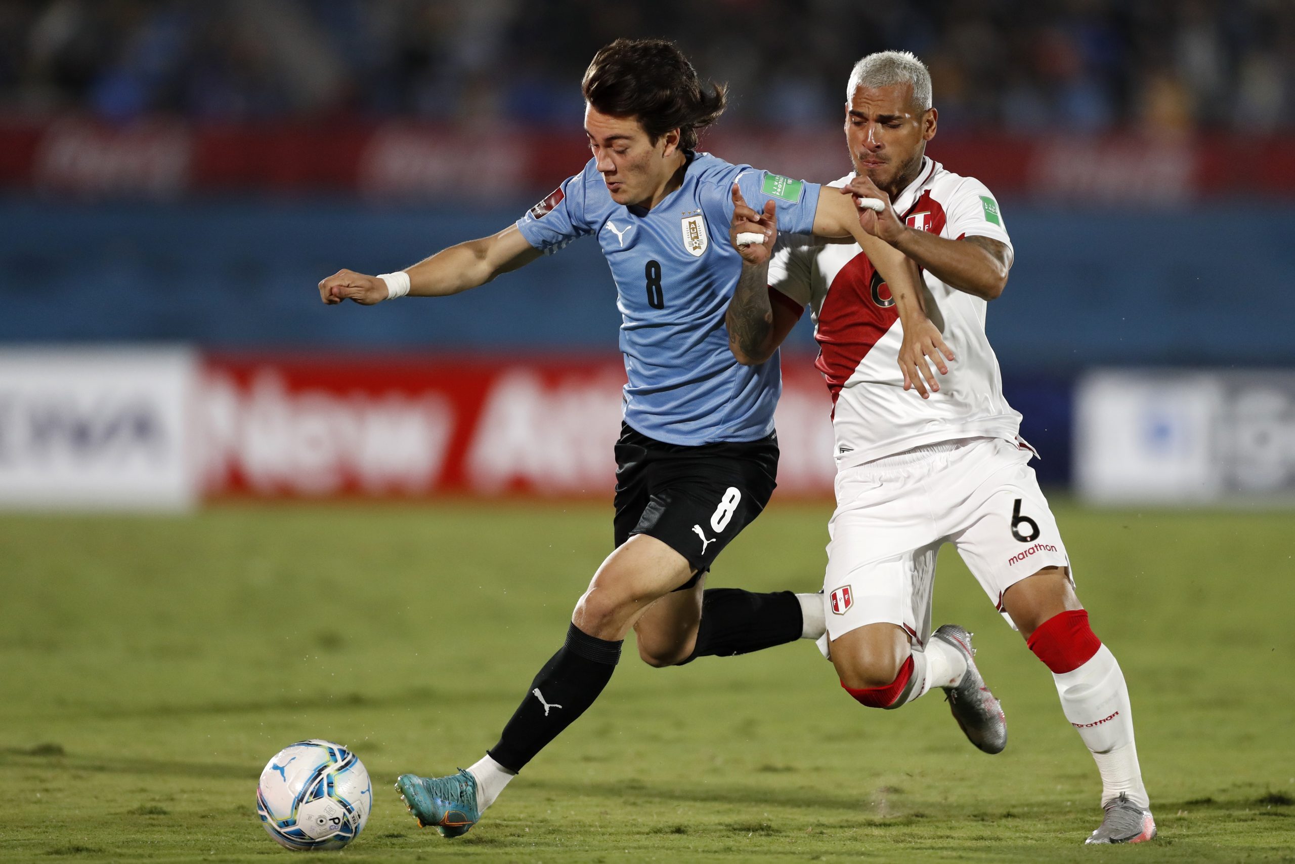 Facundo Pellistri of Uruguay fights for the ball with Miguel Trauco of Peru during a match between Uruguay and Peru as part of FIFA World Cup Qatar 2022 Qualifiers at Centenario Stadium on March 24, 2022 in Montevideo, Uruguay