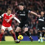 Declan Rice of West Ham United is challenged by Martin Oedegaard of Arsenal during the Premier League match between Arsenal FC and West Ham United at Emirates Stadium on December 26, 2022 in London, England.