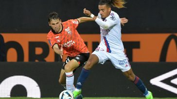 Lyon's French defender Malo Gusto (R) during the French L1 football match between Lorient and Lyon (OL) at the Stade du Moustoir in Lorient, on September 7, 2022.