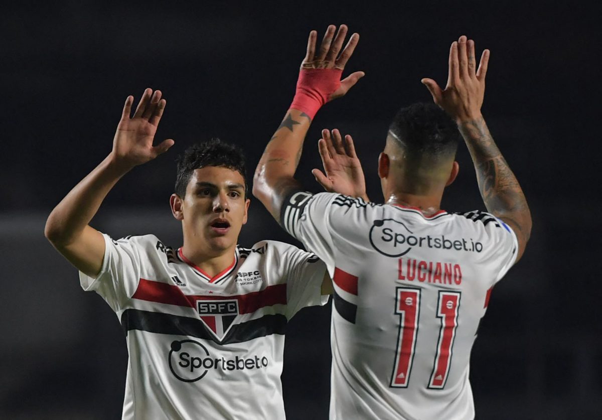 Brazil's Sao Paulo Joao Moreira (L) celebrates after scoring against Chile's Universidad Catolica during their Copa Sudamericana football tournament round of sixteen second leg match, at Morumbi Stadium in Sao Paulo, Brazil, on July 7, 2022.