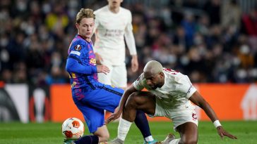 Frenkie de Jong of Barcelona is challenged by Ryan Babel of Galatasaray during the UEFA Europa League Round of 16 Leg One match between FC Barcelona and Galatasaray at Camp Nou on March 10, 2022 in Barcelona, Spain