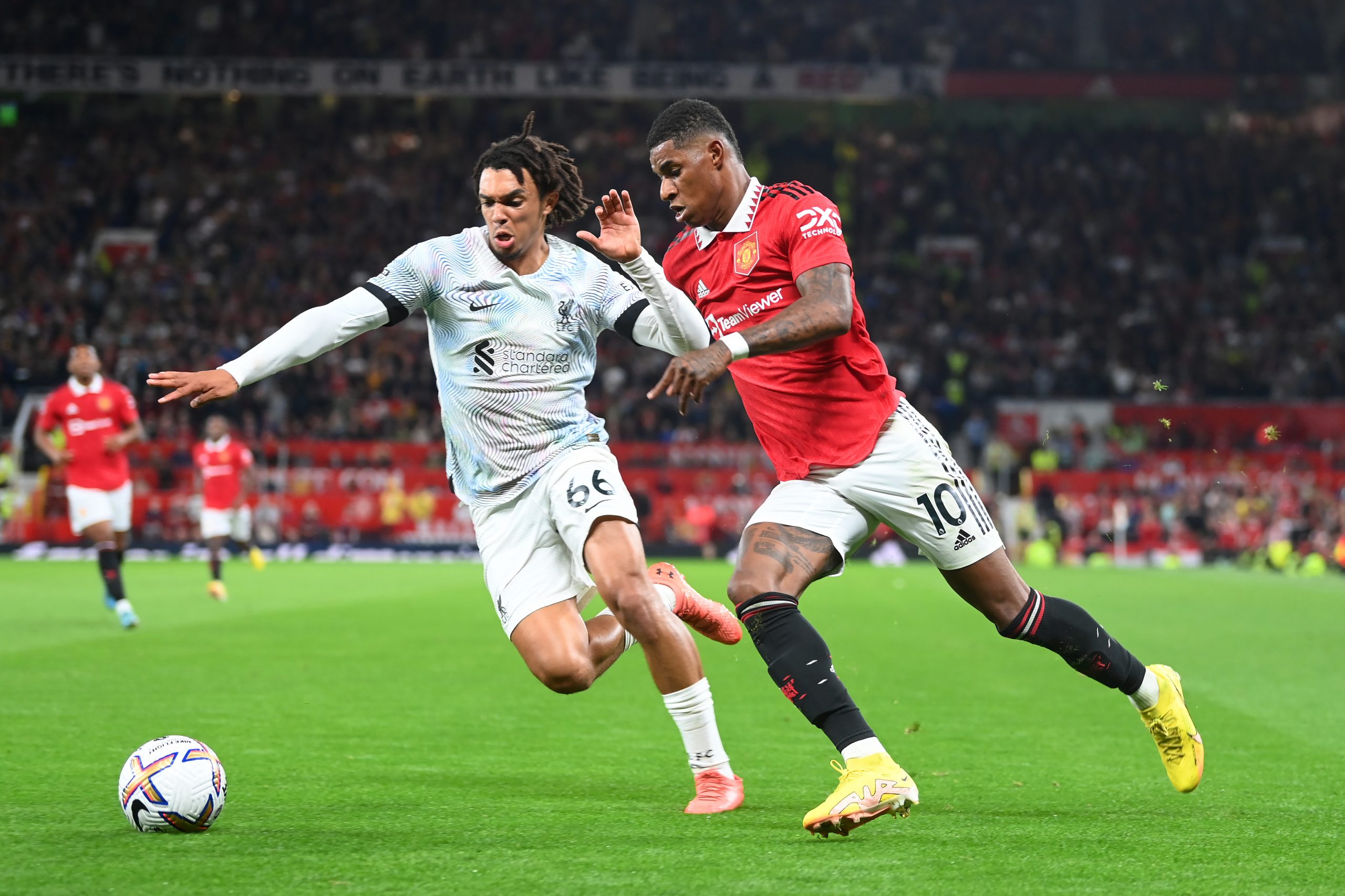 Marcus Rashford of Manchester United in action with Trent Alexander-Arnold of Liverpool during the Premier League match between Manchester United and Liverpool FC at Old Trafford on August 22, 2022 in Manchester, England.