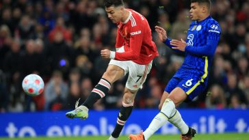 Manchester United's Portuguese striker Cristiano Ronaldo (L) shoots past Chelsea's Brazilian defender Thiago Silva (R) to score their first goal during the English Premier League football match between Manchester United and Chelsea at Old Trafford in Manchester, north west England, on April 28, 2022