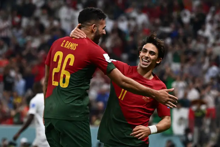 Portugal's forward Goncalo Ramos and Portugal's forward Joao Felix celebrate after Portugal's defender #05 Raphael Guerreiro (unseen) scored his team's fourth goal during the Qatar 2022 World Cup round of 16 football match between Portugal and Switzerland at Lusail Stadium in Lusail, north of Doha on December 6, 2022.