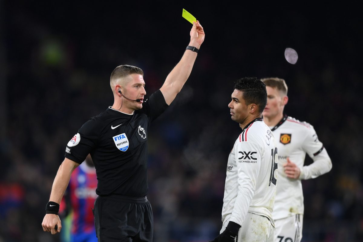 Referee Robert Jones gives a yellow card to Casemiro of Manchester United during the Premier League match between Crystal Palace and Manchester United at Selhurst Park on January 18, 2023 in London, England.