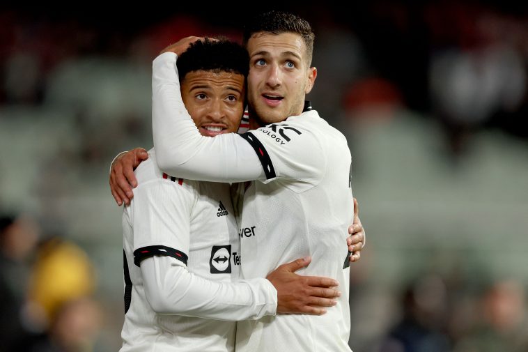 Manchester United's Jadon Sancho celebrates a goal with teammate Diogo Dalot during the pre-season football match between English Premier League teams Manchester United and Crystal Palace at the Melbourne Cricket Ground (MCG) on July 19, 2022, in Melbourne