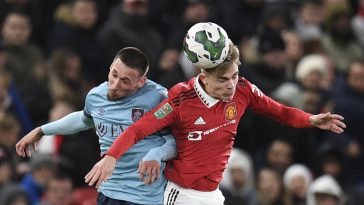 Burnley's Macedonian striker Darko Churlinov (L) fights for the ball with Manchester United's English defender Brandon Williams during the English League Cup fourth round football match between Manchester United and Burnley, at Old Trafford, in Manchester, on December 21, 2022.