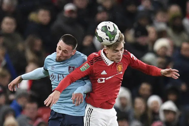 Burnley's Macedonian striker Darko Churlinov (L) fights for the ball with Manchester United's English defender Brandon Williams during the English League Cup fourth round football match between Manchester United and Burnley, at Old Trafford, in Manchester, on December 21, 2022.