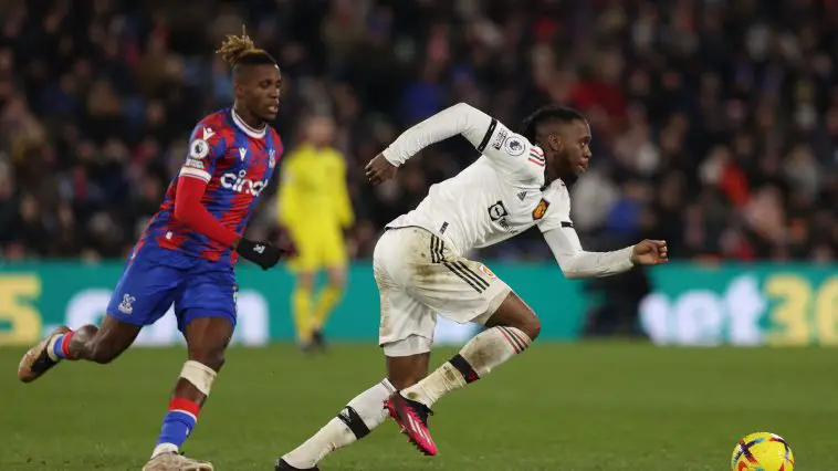 Manchester United's English defender Aaron Wan-Bissaka (R) runs with the ball during the English Premier League football match between Crystal Palace and Manchester United at Selhurst Park in south London on January 18, 2023