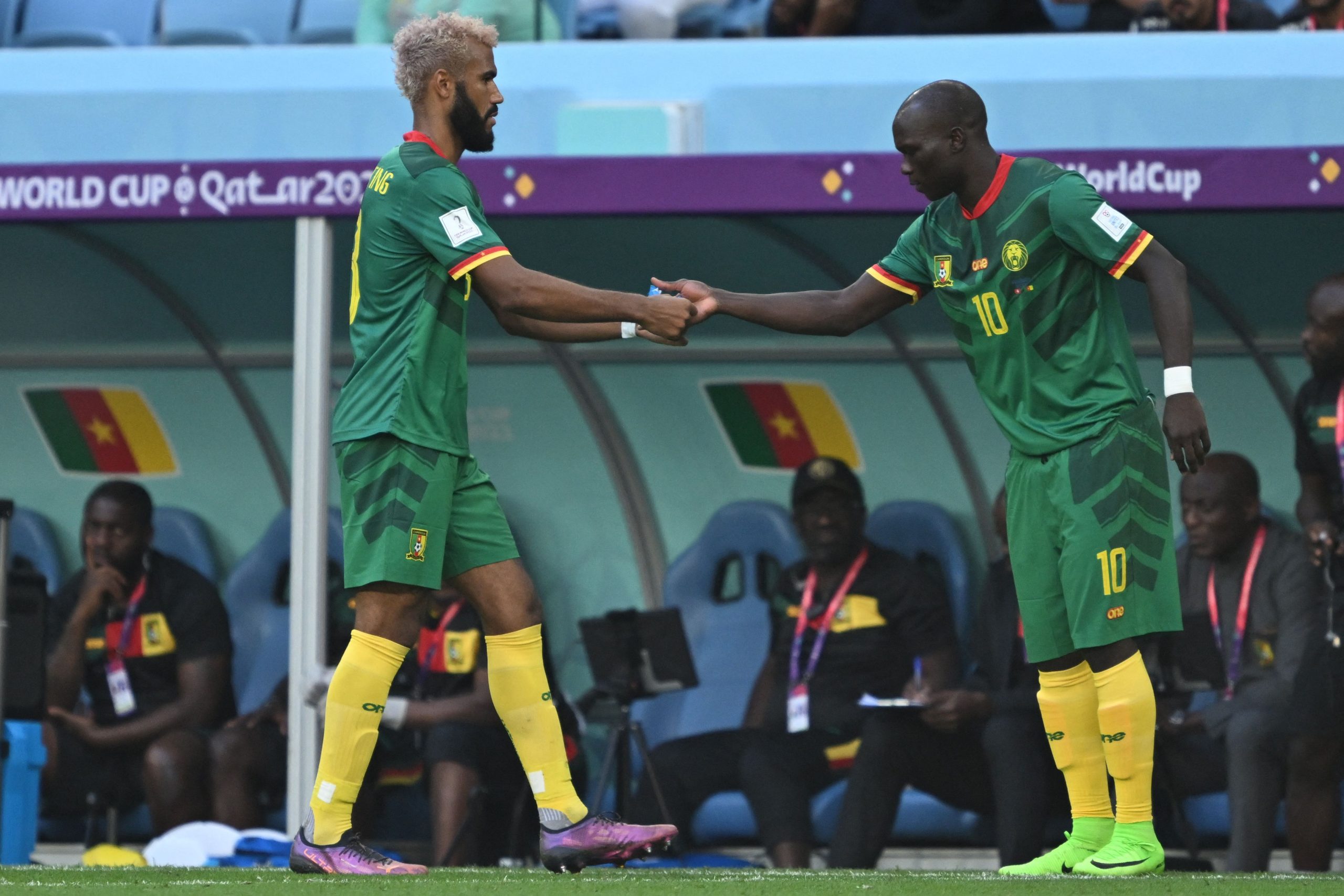 Cameroon's forward Eric Maxim Choupo-Moting hands the captain's armband to Cameroon's forward #10 Vincent Aboubakar after being substituted during the Qatar 2022 World Cup Group G football match between Switzerland and Cameroon at the Al-Janoub Stadium in Al-Wakrah, south of Doha on November 24, 2022.