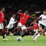Kobbie Mainoo of Manchester United controls the ball under pressure from Ryan Inniss of Charlton Athletic during the Carabao Cup Quarter Final match between Manchester United and Charlton Athletic at Old Trafford on January 10, 2023 in Manchester, England