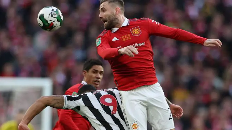 Manchester United's English defender Luke Shaw (R) wins a header, under pressure from Newcastle United's English striker Callum Wilson (C) during the English League Cup final football match between Manchester United and Newcastle United at Wembley Stadium, north-west London on February 26, 2023
