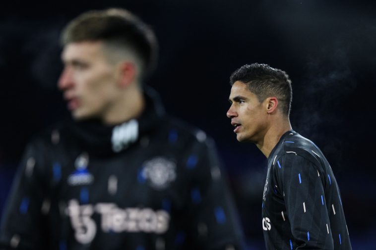 Manchester United's Raphael Varane and Lisandro Martinez warm up prior to the English Premier League football match between Crystal Palace and Manchester United at Selhurst Park in south London on January 18, 2023.