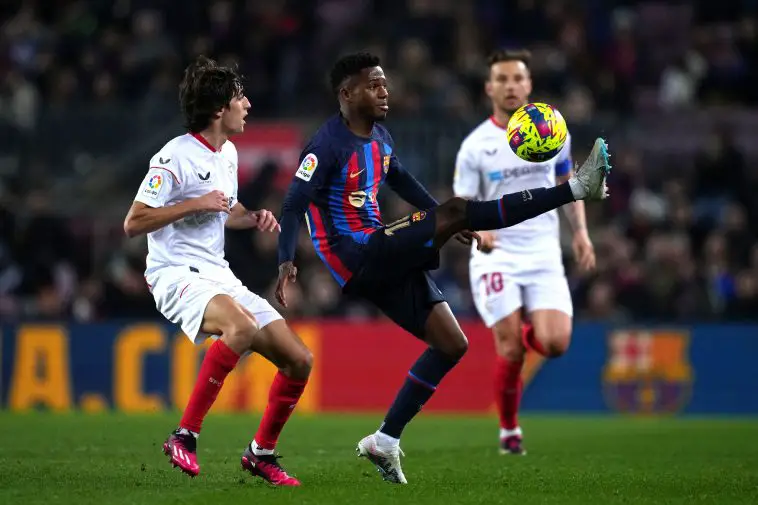 Ansu Fati of FC Barcelona is challenged by Bryan Gil of Sevilla FC during the LaLiga Santander match between FC Barcelona and Sevilla FC at Spotify Camp Nou on February 05, 2023 in Barcelona, Spain.