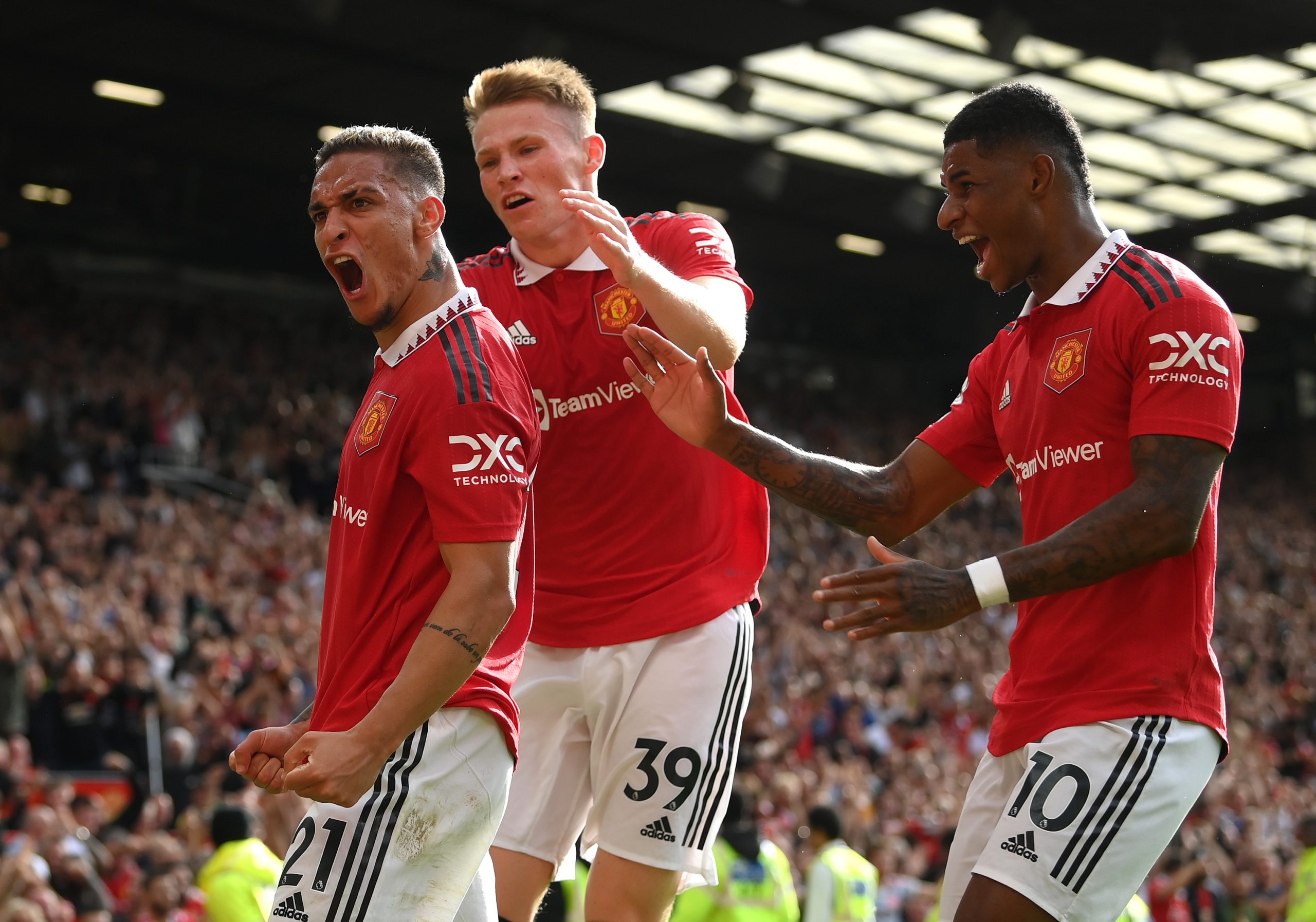 Antony of Manchester United celebrates with team mates Scott McTominay and Marcus Rashford after scoring during the Premier League match between Manchester United and Arsenal FC at Old Trafford on September 04, 2022 in Manchester, England