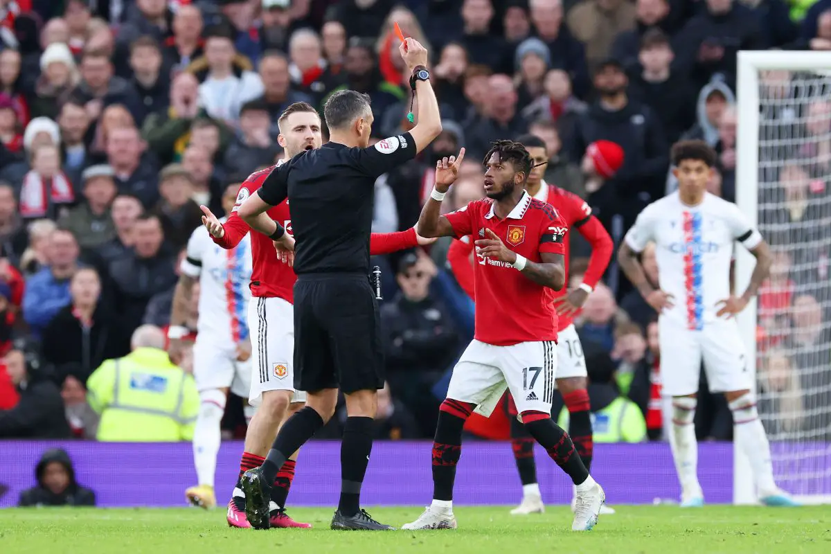Match referee Andre Marriner shows a red card to Casemiro of Manchester United (not pictured) during the Premier League match between Manchester United and Crystal Palace at Old Trafford on February 04, 2023 in Manchester, England.