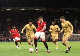 Wout Weghorst of Manchester United passes the ball while under pressure from Alejandro Balde and Andreas Christensen of FC Barcelona during the UEFA Europa League knockout round play-off leg two match between Manchester United and FC Barcelona at Old Trafford on February 23, 2023 in Manchester, England