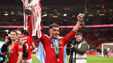 Lisandro Martinez of Manchester United celebrates with the Carabao Cup trophy following victory in the Carabao Cup Final match between Manchester United and Newcastle United at Wembley Stadium on February 26, 2023 in London, England