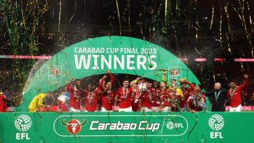 Bruno Fernandes and Harry Maguire of Manchester United lift the Carabao Cup trophy.