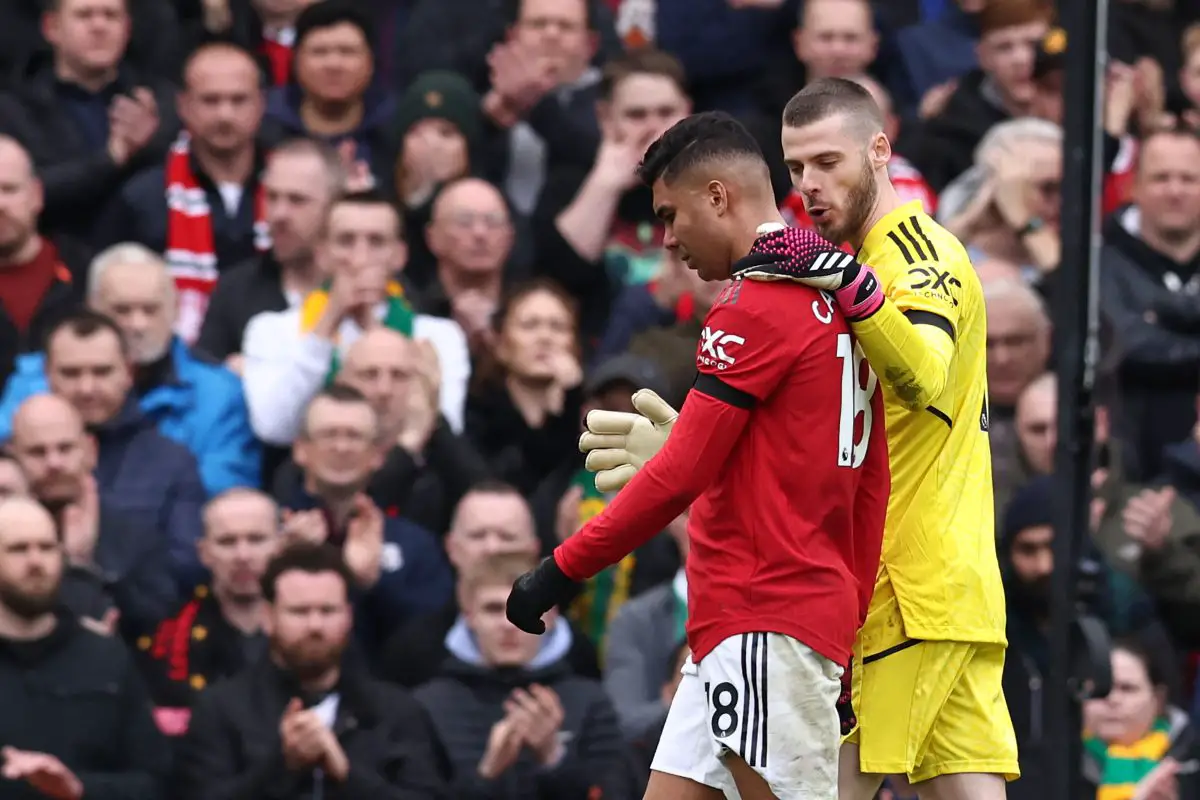 Manchester United's Brazilian midfielder Casemiro (L) is consoled by Manchester United's Spanish goalkeeper David de Gea (R) as walks off after being shown a red card by English referee Anthony Taylor during the English Premier League football match between Manchester United and Southampton at Old Trafford in Manchester, north-west England, on March 12, 2023. (Photo by Darren Staples / AFP) / RESTRICTED TO EDITORIAL USE. No use with unauthorized audio, video, data, fixture lists, club/league logos or 'live' services. Online in-match use limited to 120 images. An additional 40 images may be used in extra time. No video emulation. Social media in-match use limited to 120 images. An additional 40 images may be used in extra time. No use in betting publications, games or single club/league/player publications. 