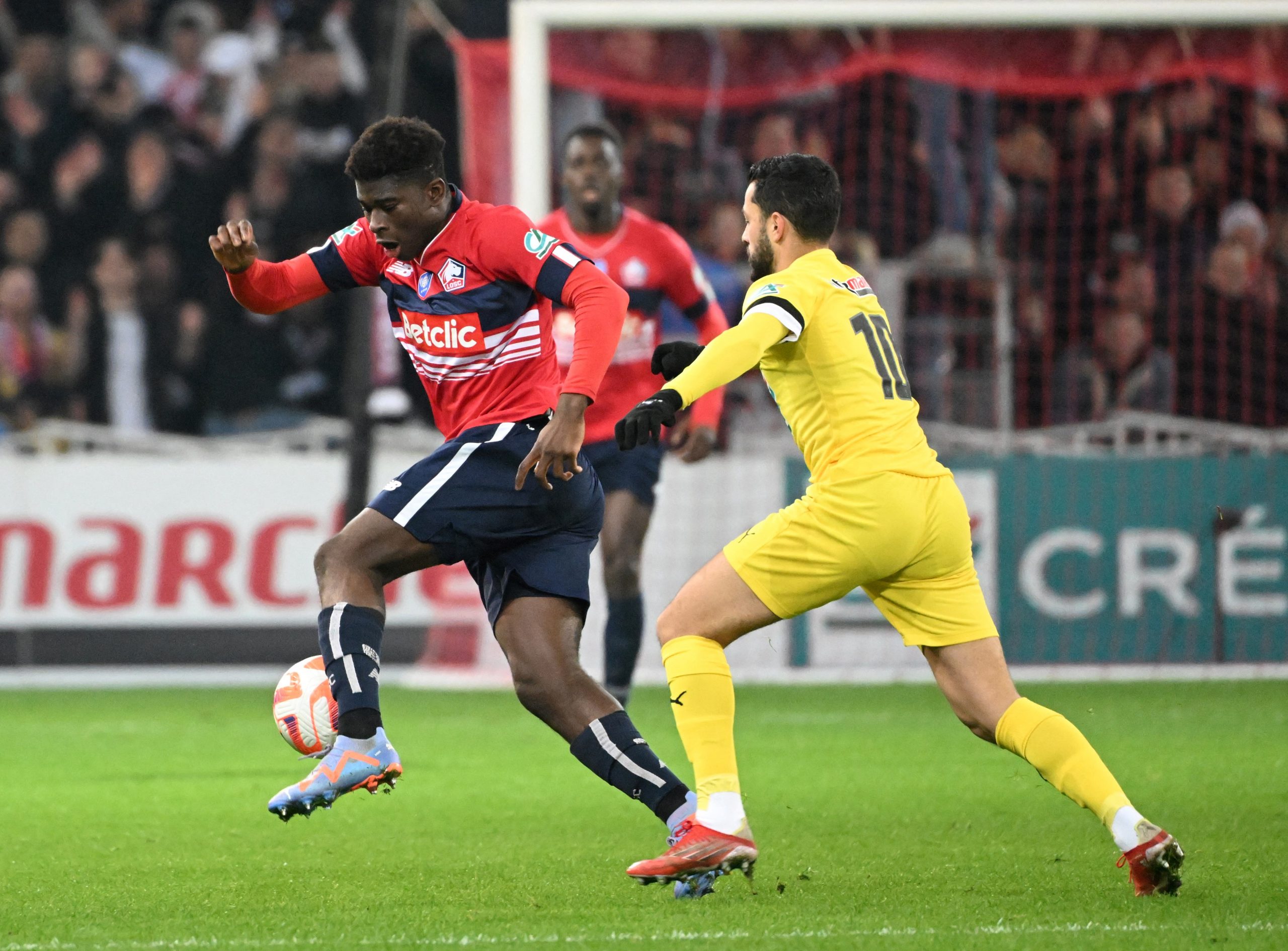 Pau' midfielder Eddy Sylvestre fights for the ball with Lille's midfeilder Carlos Baleba.