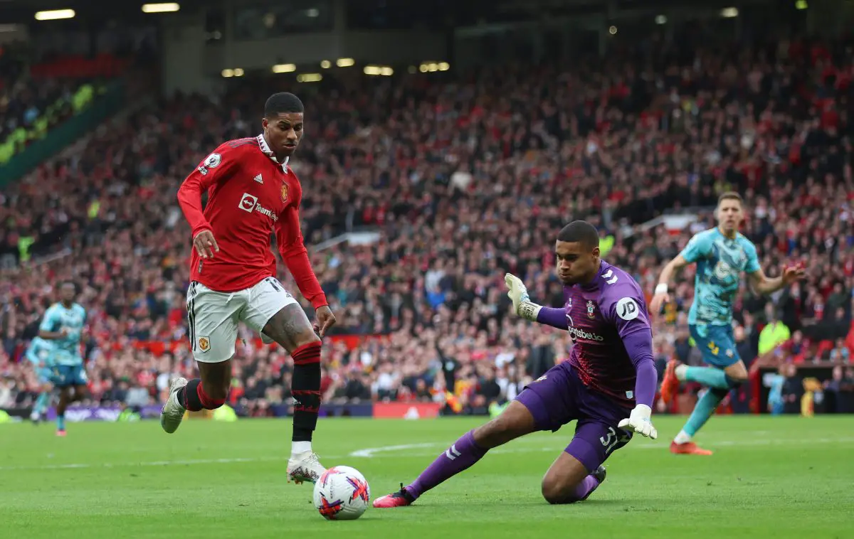 MANCHESTER, ENGLAND - MARCH 12: Marcus Rashford of Manchester United runs with the ball past Gavin Bazunu of Southampton during the Premier League match between Manchester United and Southampton FC at Old Trafford on March 12, 2023 in Manchester, England