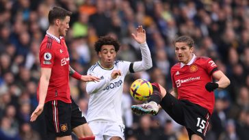 Wout Weghorst of Manchester United looks on as Tyler Adams of Leeds is challenged by Marcel Sabitzer.
