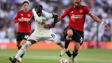 Yves Bissouma of Tottenham Hotspur battles for possession with Bruno Fernandes of Manchester United.