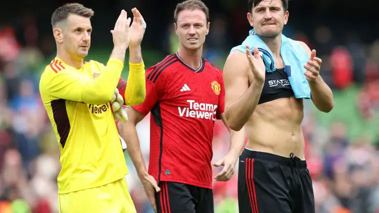 Manchester United's English goalkeeper Tom Heaton, Jonny Evans (C) and Harry Maguire (R) applaud fans.