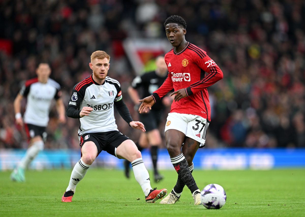 MANCHESTER, ENGLAND - FEBRUARY 24: Kobbie Mainoo of Manchester United is put under pressure by Harrison Reed of Fulham during the Premier League match between Manchester United and Fulham FC at Old Trafford on February 24, 2024 in Manchester, England. (Photo by Michael Regan/Getty Images)