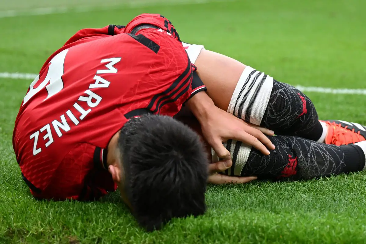 MANCHESTER, ENGLAND - FEBRUARY 04: Lisandro Martinez of Manchester United lies injured during the Premier League match between Manchester United and West Ham United at Old Trafford on February 04, 2024 in Manchester, England. (Photo by Michael Regan/Getty Images)