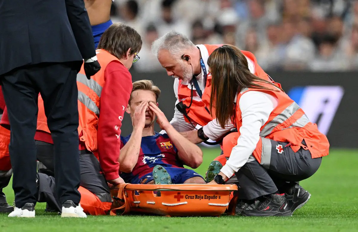 MADRID, SPAIN - APRIL 21: Frenkie de Jong of FC Barcelona is placed onto a stretcher after suffering an injury during the LaLiga EA Sports match between Real Madrid CF and FC Barcelona at Estadio Santiago Bernabeu on April 21, 2024 in Madrid, Spain. (Photo by David Ramos/Getty Images)